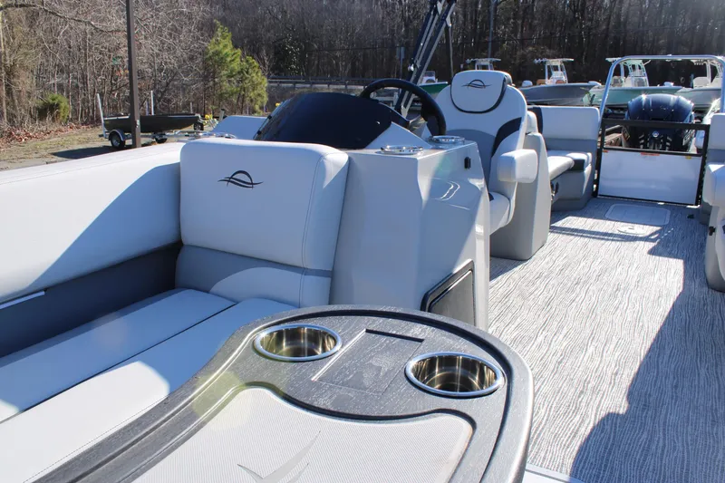 Slide: The Image of 2025 SunCatcher Select 324RC pontoon boat interior with plush seating and cup holders. - 14