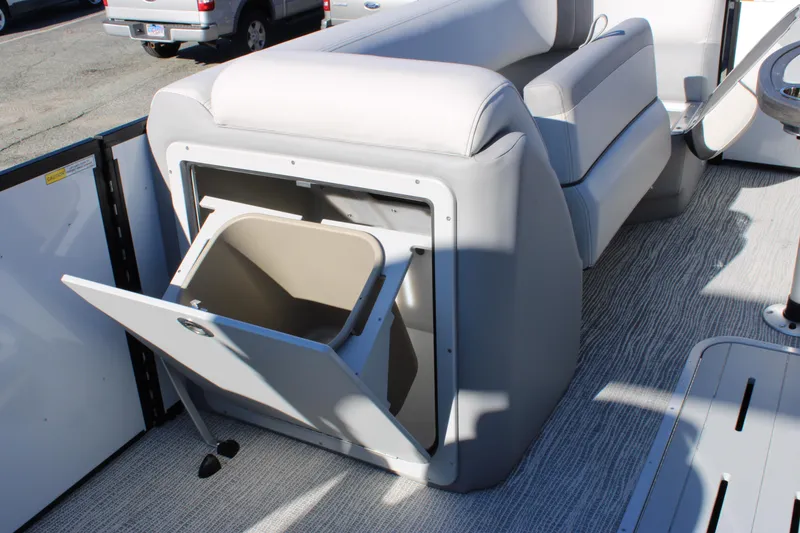 Slide: The Image of 2025 SunCatcher Select 324RC boat interior with open storage compartment and seating. - 18