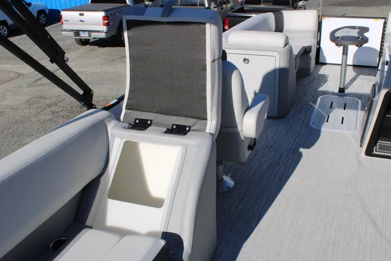 Slide: The Image of 2025 SunCatcher Select 324RC boat interior with gray seating and storage compartments. - 21