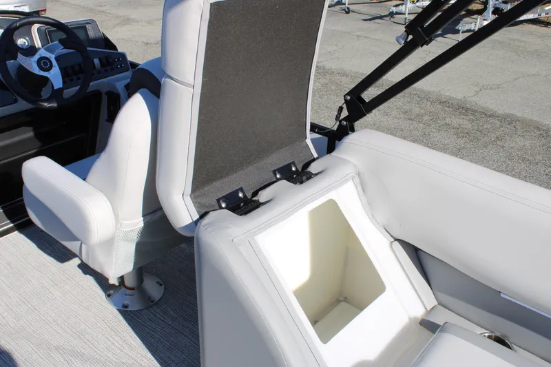 Slide: The Image of 2025 SunCatcher Select 324RC boat interior with open storage compartment and seating. - 22