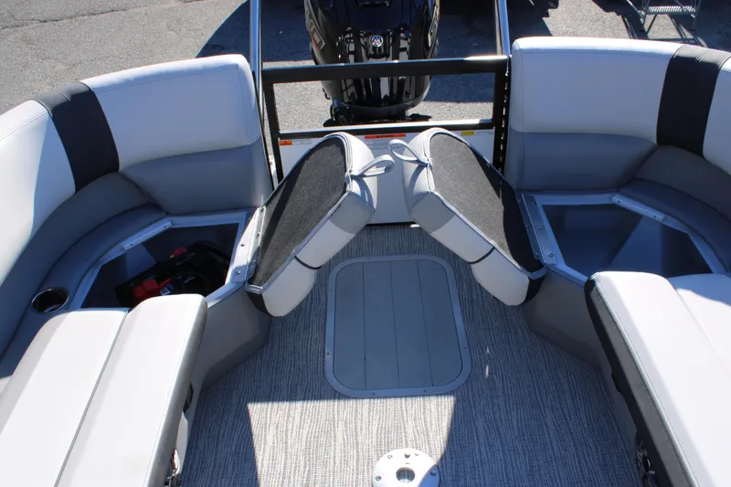 Slide: The Image of 2025 SunCatcher Select 324RC boat interior with cushioned seating and storage compartments. - 23