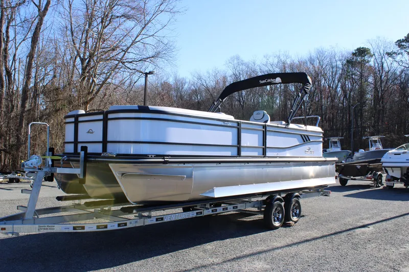 Slide: The Image of 2025 SunCatcher Select 324RC pontoon boat on trailer in outdoor setting. - 3