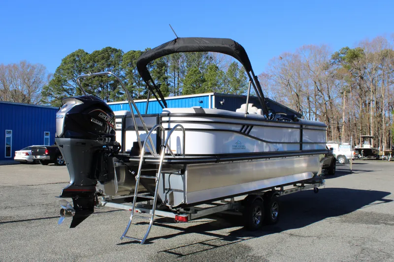 Slide: The Image of 2025 SunCatcher Select 324RC pontoon boat on trailer, parked outdoors. - 4