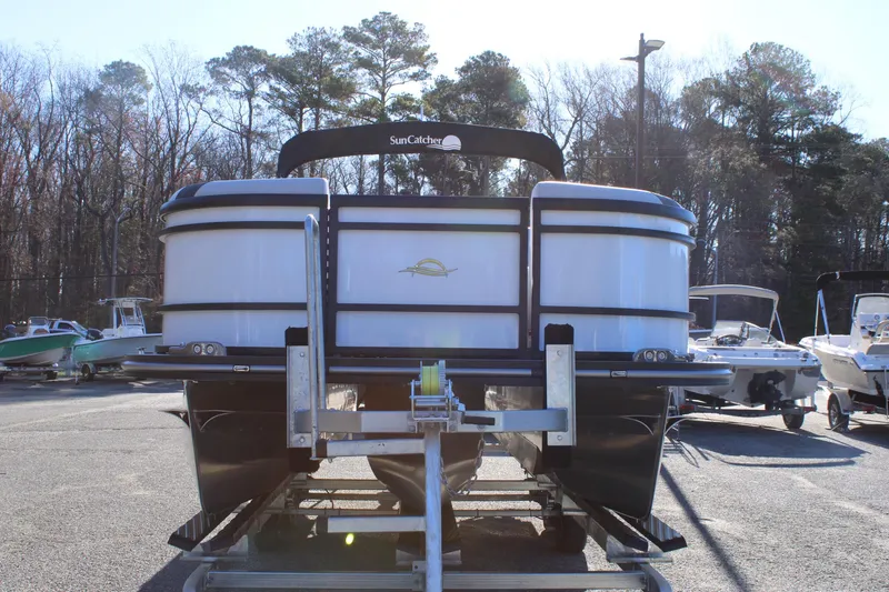 Slide: The Image of 2025 SunCatcher Select 324RC pontoon boat on trailer in outdoor setting. - 7