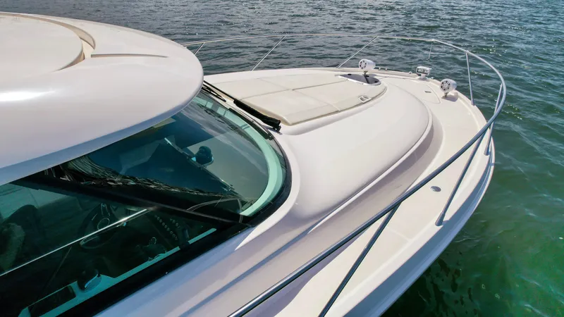 Slide: The Image of 2017 Tiara Yachts 44 Coupe on water, showcasing sleek design and spacious deck. - 10