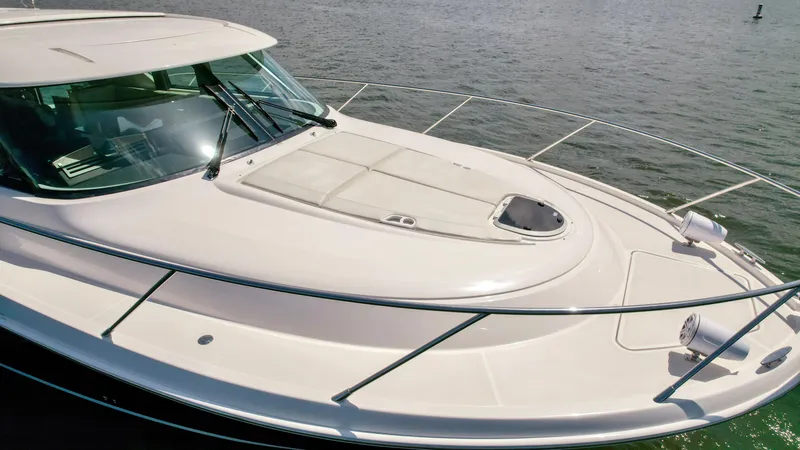 Slide: The Image of 2017 Tiara Yachts 44 Coupe on water, showcasing sleek design and spacious deck. - 11