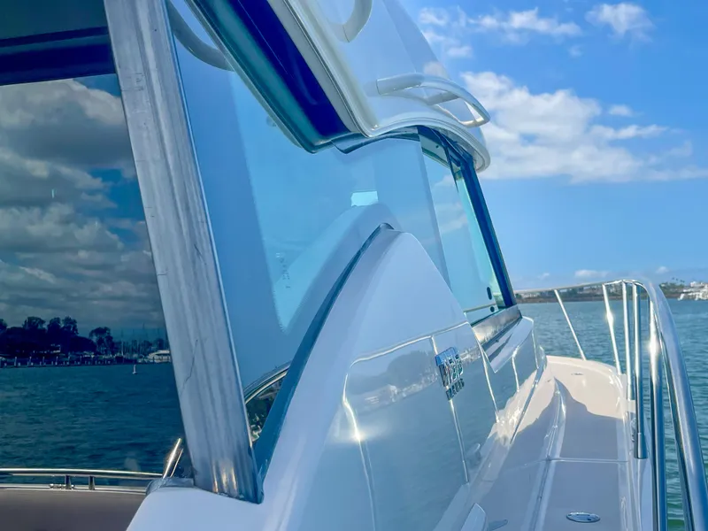 Slide: The Image of 2017 Tiara Yachts 44 Coupe on water, reflecting blue sky and clouds. - 12