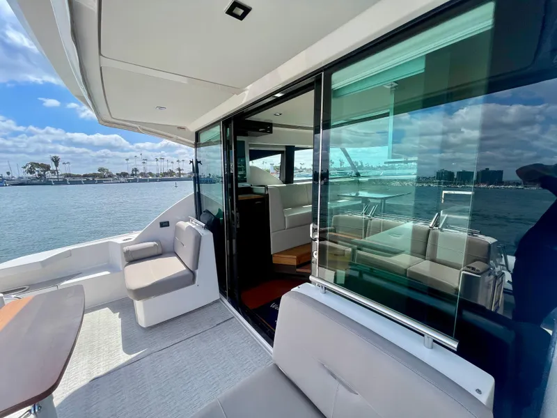 Slide: The Image of 2017 Tiara Yachts 44 Coupe with spacious deck and modern interior, docked by the water. - 13