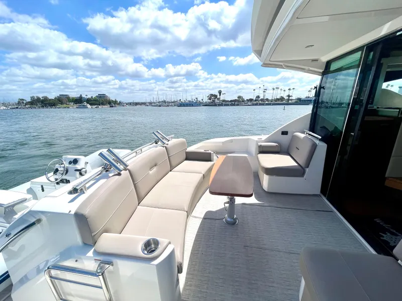 Slide: The Image of 2017 Tiara Yachts 44 Coupe deck with seating, table, and ocean view. - 14