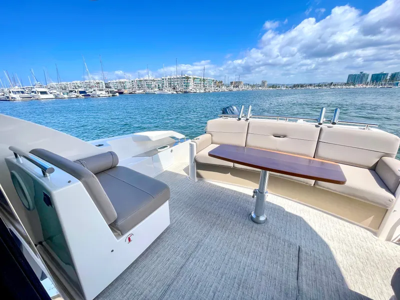 Slide: The Image of 2017 Tiara Yachts 44 Coupe with spacious deck, comfortable seating, and scenic marina view. - 15
