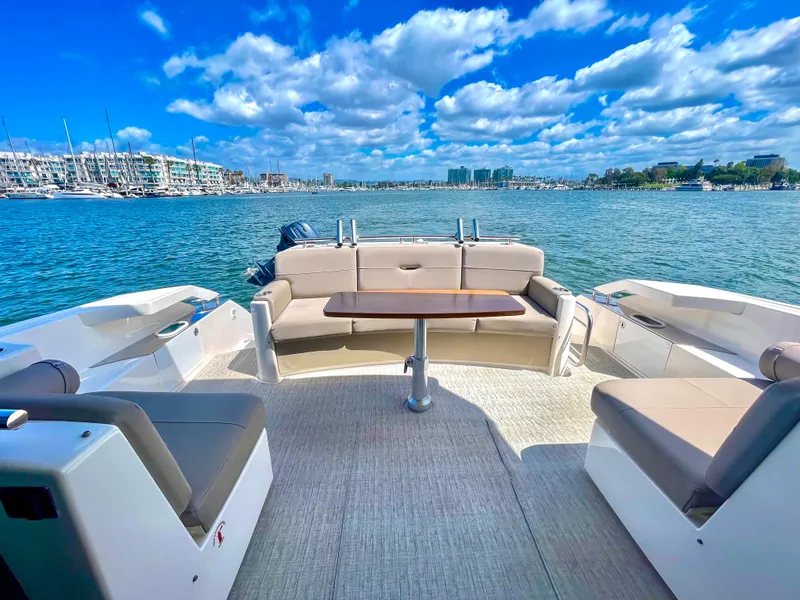 Slide: The Image of 2017 Tiara Yachts 44 Coupe deck with seating, table, and ocean view. - 16