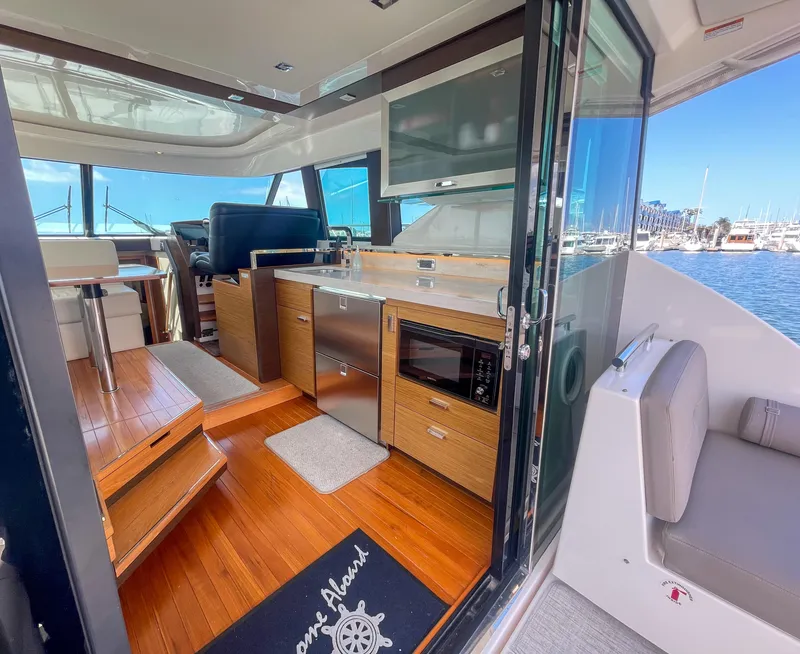 Slide: The Image of Interior of 2017 Tiara Yachts 44 Coupe with modern kitchen and seating area. - 19