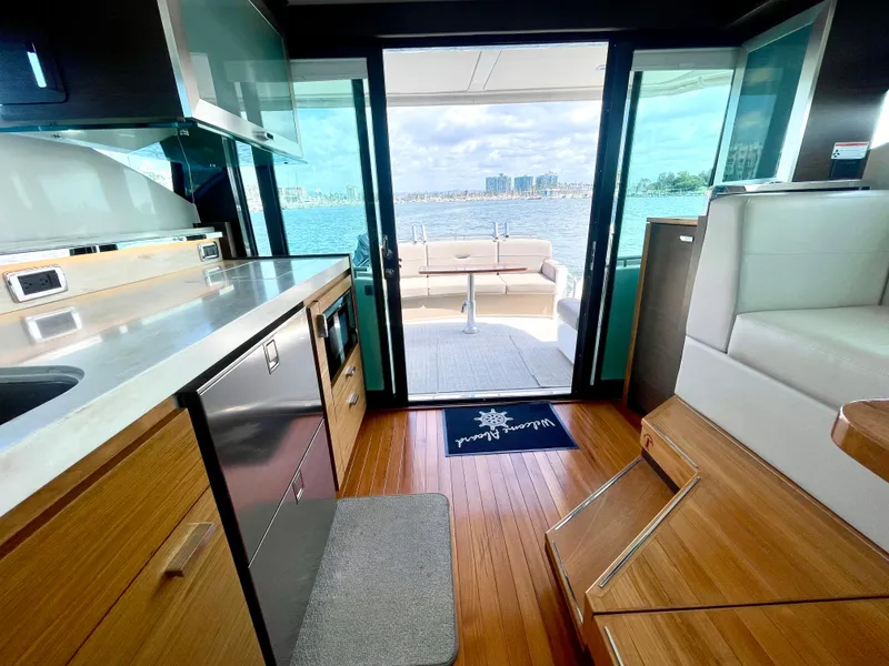 Slide: The Image of Interior of 2017 Tiara Yachts 44 Coupe with modern kitchen and ocean view. - 20