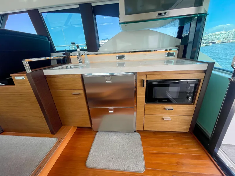 Slide: The Image of Interior of 2017 Tiara Yachts 44 Coupe featuring modern kitchen with stainless appliances. - 22
