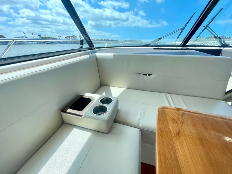 Slide: The Image of Interior of 2017 Tiara Yachts 44 Coupe with white seating and wooden table. - 25