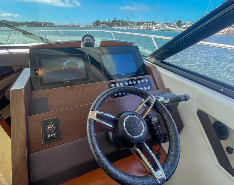 Slide: The Image of Helm of 2017 Tiara Yachts 44 Coupe with navigation screens and steering wheel. - 28