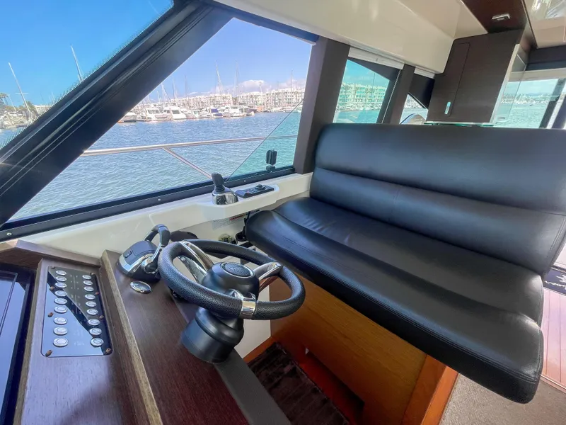 Slide: The Image of Interior helm of 2017 Tiara Yachts 44 Coupe with leather seating and steering wheel. - 29