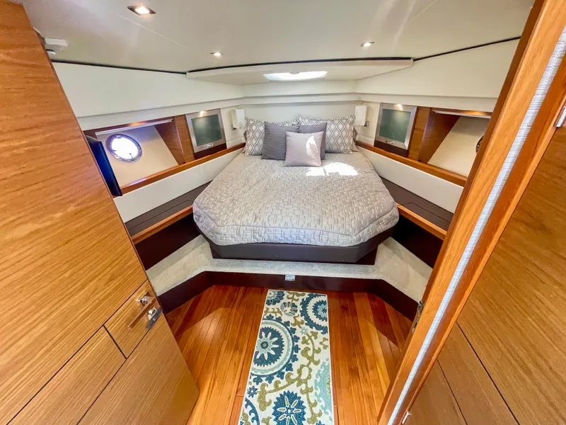 Slide: The Image of Luxurious bedroom interior of 2017 Tiara Yachts 44 Coupe with elegant bedding and wood accents. - 30