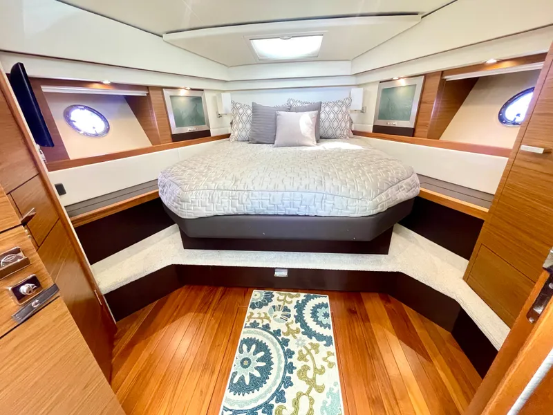 Slide: The Image of Luxurious bedroom interior of 2017 Tiara Yachts 44 Coupe with elegant bedding and wood flooring. - 31