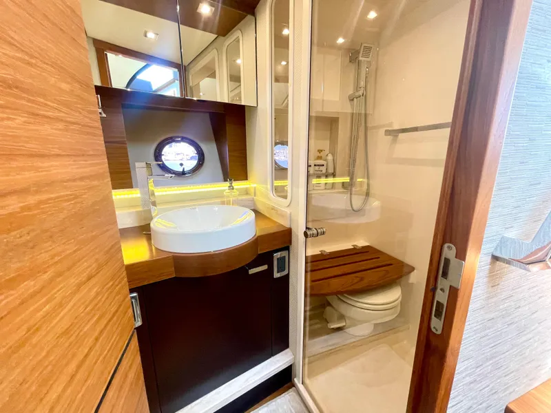 Slide: The Image of Luxurious bathroom in 2017 Tiara Yachts 44 Coupe, featuring modern fixtures and elegant wood accents. - 37
