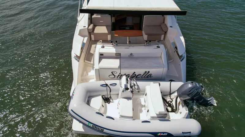 Slide: The Image of 2017 Tiara Yachts 44 Coupe with inflatable boat on water. - 4