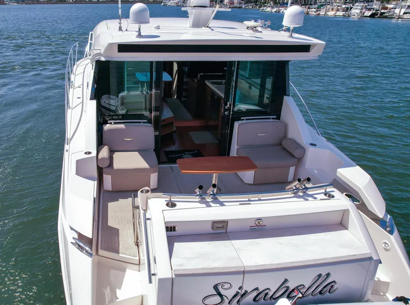 Slide: The Image of 2017 Tiara Yachts 44 Coupe on water, featuring spacious deck and luxurious seating. - 5