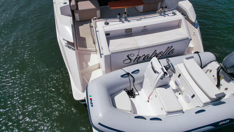 Slide: The Image of Tiara Yachts 2017 44 Coupe with tender boat on water. - 6