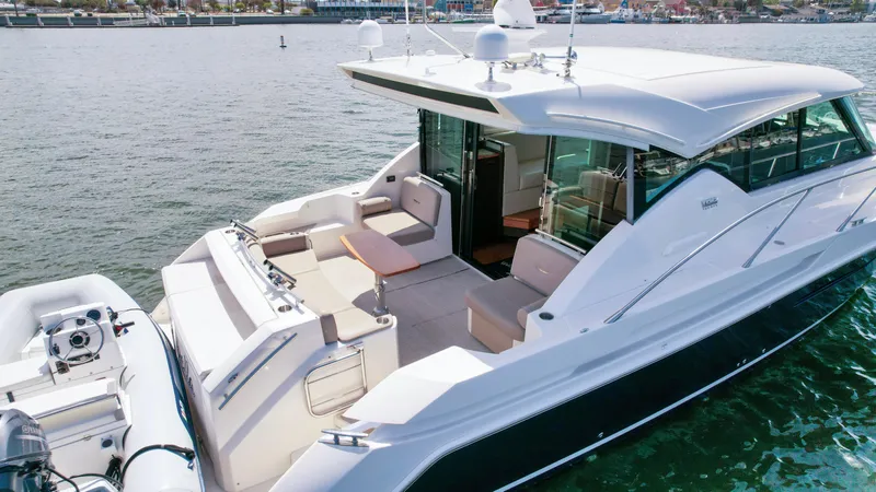 Slide: The Image of 2017 Tiara Yachts 44 Coupe on water, featuring spacious deck and modern design. - 7