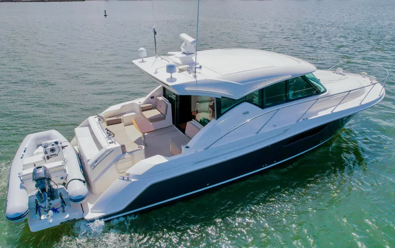 Slide: The Image of 2017 Tiara Yachts 44 Coupe cruising on water, featuring sleek design and spacious deck. - 8