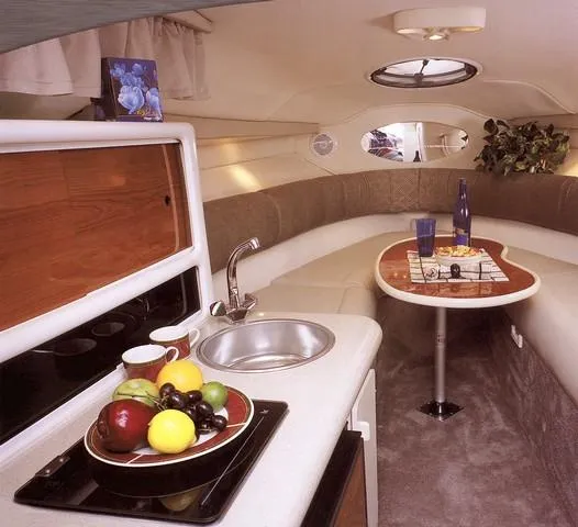 Slide: The Image of 2001 Monterey 262 Cruiser boat on trailer with green canopy and dual axles. - 11