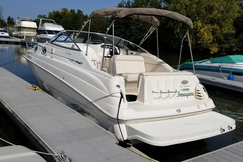 Slide: The Image of 2001 Monterey 262 Cruiser boat docked in a marina, surrounded by other boats. - 5