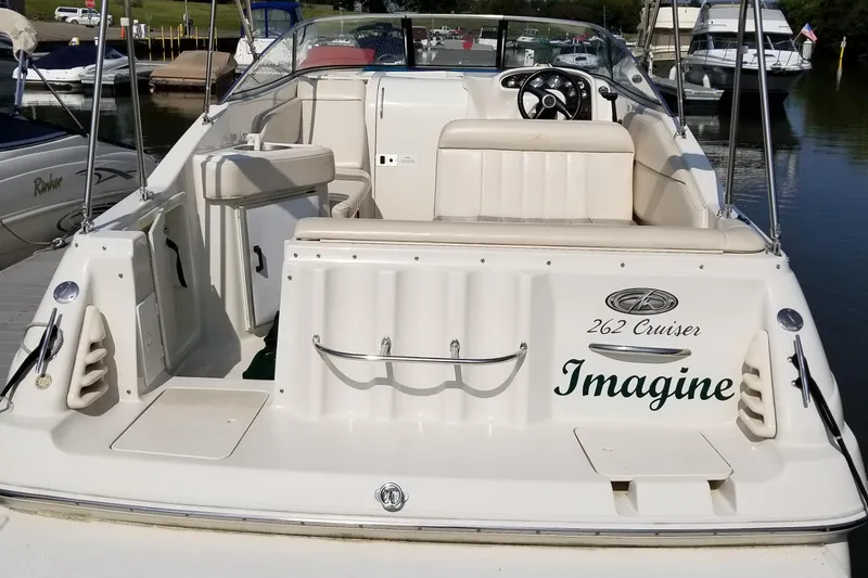 Slide: The Image of 2001 Monterey 262 Cruiser docked, featuring a sleek white design and spacious seating. - 6