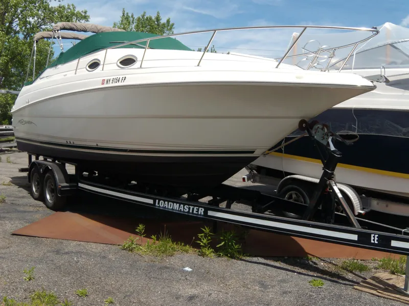 Slide: The Image of 2001 Monterey 262 Cruiser boat named "Imagine" docked with fenders attached. - 9