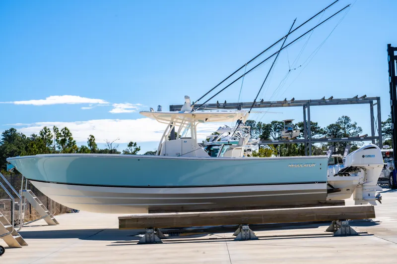 The Image of 2019 Regulator 34 boat on display, light blue hull, outdoor setting. - 0