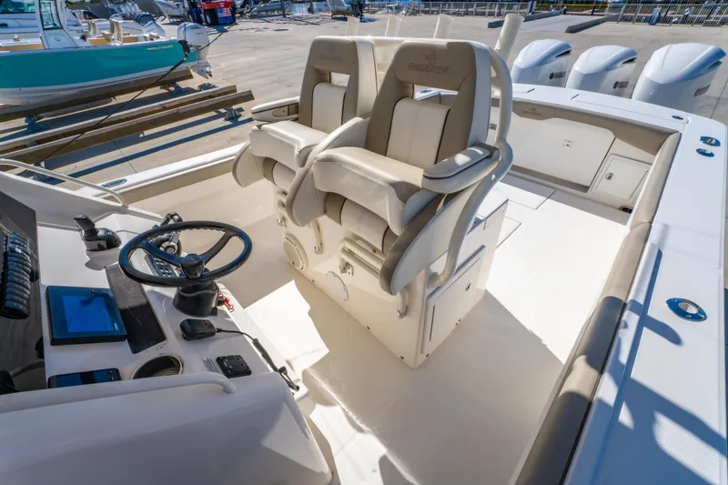 Slide: The Image of 2019 Regulator 34 boat cockpit with dual helm seats and steering wheel. - 12