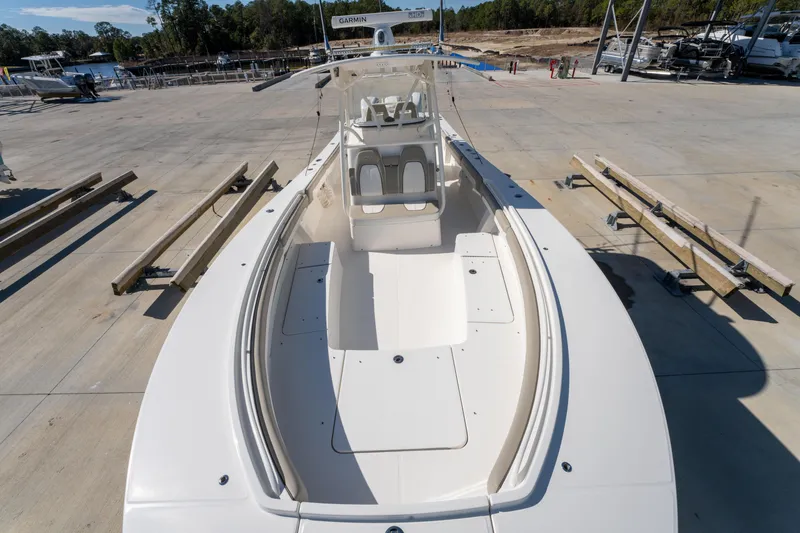 Slide: The Image of 2019 Regulator 34 boat on dry dock, showcasing spacious deck and seating area. - 19