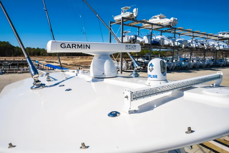 Slide: The Image of 2019 Regulator 34 boat with Garmin and FLIR equipment on deck, docked under clear blue sky. - 20