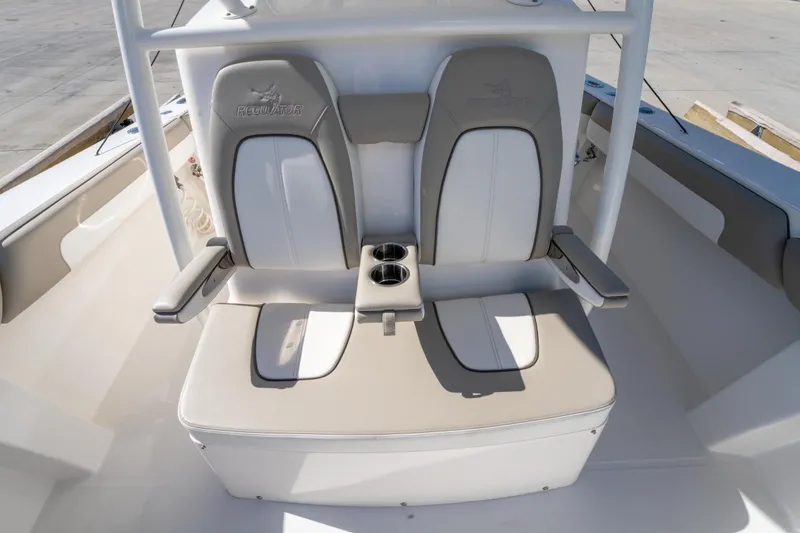 Slide: The Image of 2019 Regulator 34 boat seating with dual chairs and cup holders. - 21