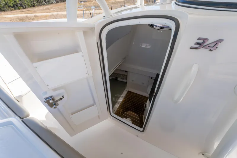 Slide: The Image of 2019 Regulator 34 boat cabin entrance with open door, showcasing interior space. - 23