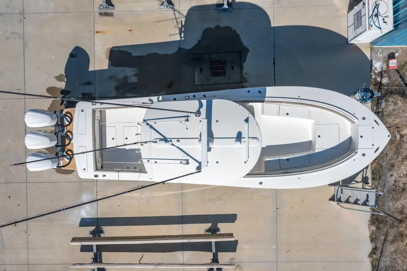 Slide: The Image of Aerial view of 2019 Regulator 34 boat on concrete surface with triple engines. - 24