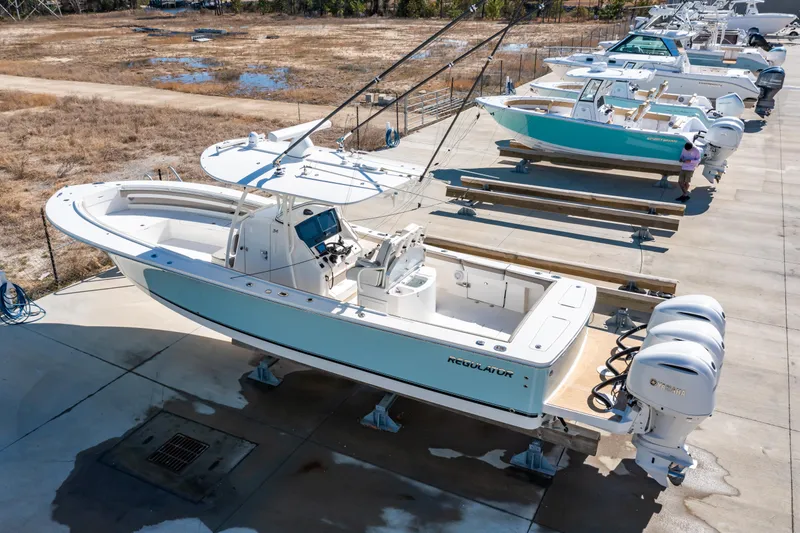 Slide: The Image of 2019 Regulator 34 boat with dual engines, docked on a concrete platform. - 25