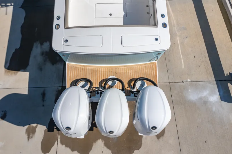 Slide: The Image of 2019 Regulator 34 boat with triple outboard engines, aerial view. - 26