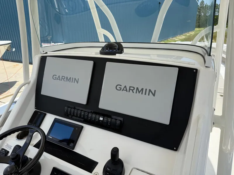 Slide: The Image of 2019 Regulator 34 boat dashboard with dual Garmin displays and controls. - 29