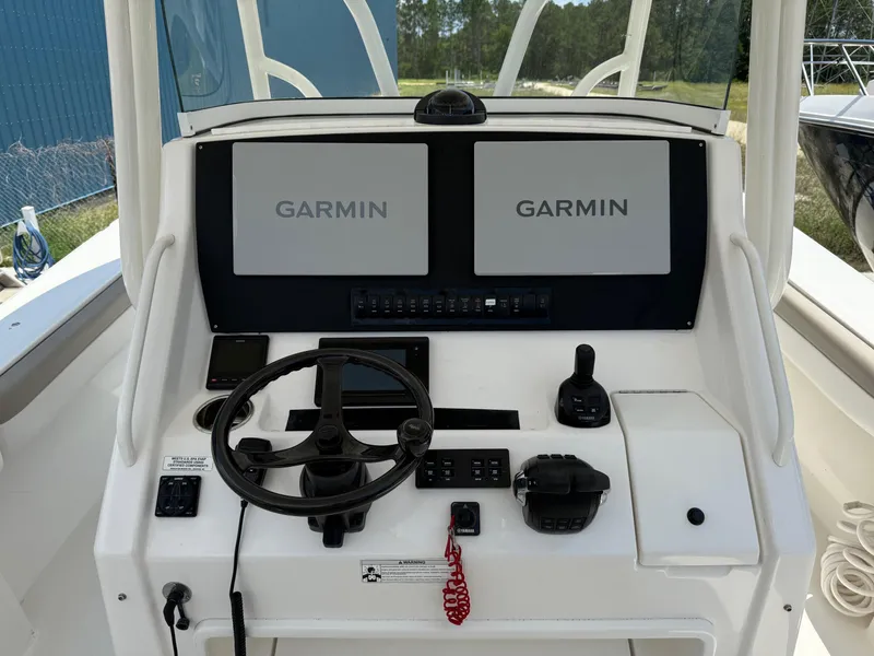 Slide: The Image of 2019 Regulator 34 boat helm with dual Garmin displays and steering wheel. - 30
