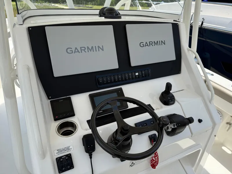 Slide: The Image of 2019 Regulator 34 boat helm with dual Garmin displays and steering wheel. - 31