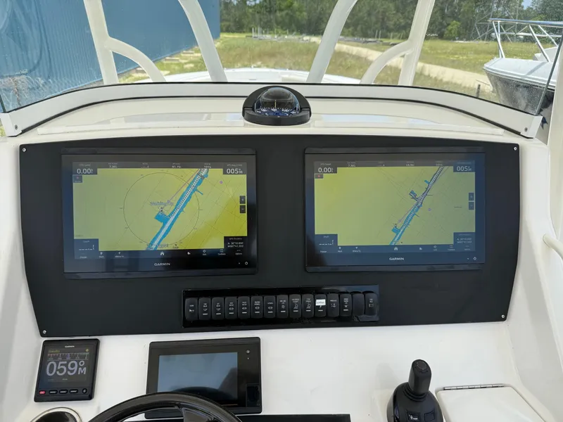 Slide: The Image of Control panel of a 2019 Regulator 34 boat with dual navigation screens. - 33