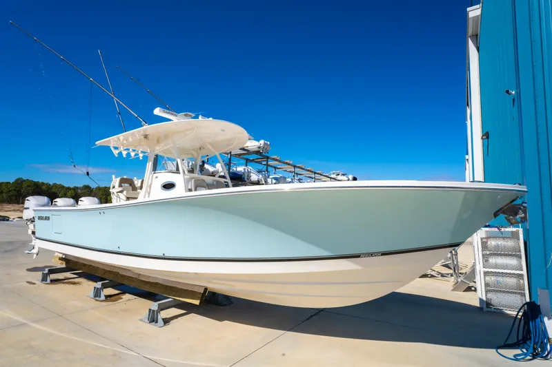 Slide: The Image of 2019 Regulator 34 boat on display, light blue hull, clear sky background. - 5