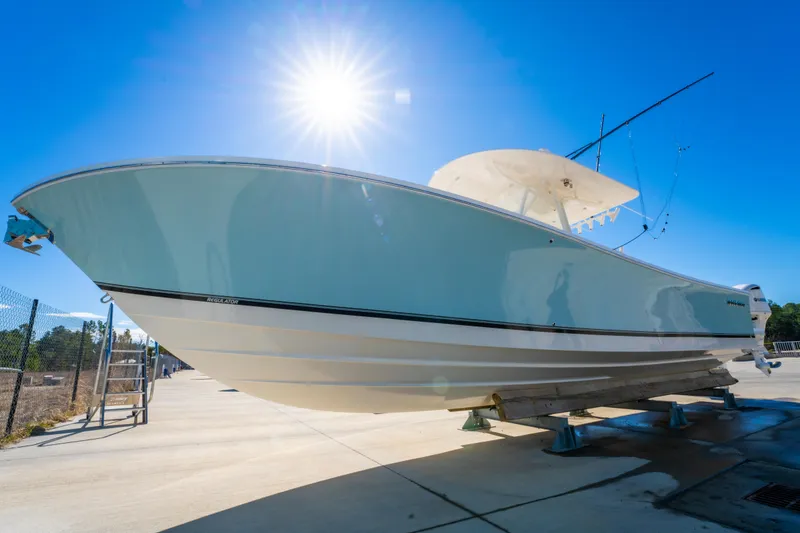 Slide: The Image of 2019 Regulator 34 boat on display under bright sun. - 6