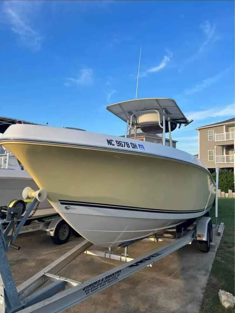Slide: The Image of 2008 Clearwater 2500 boat on trailer, parked outdoors under blue sky. - 1