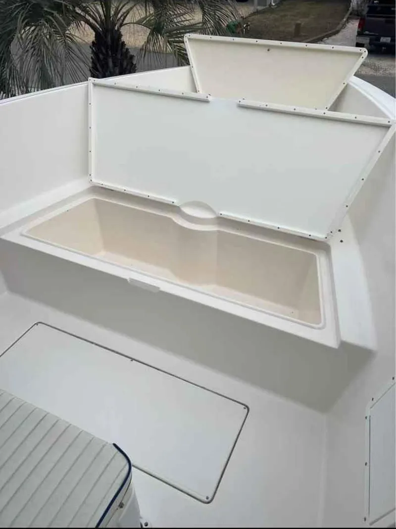 Slide: The Image of 2008 Clearwater 2500 boat storage compartment with open hatch, showcasing spacious interior. - 11